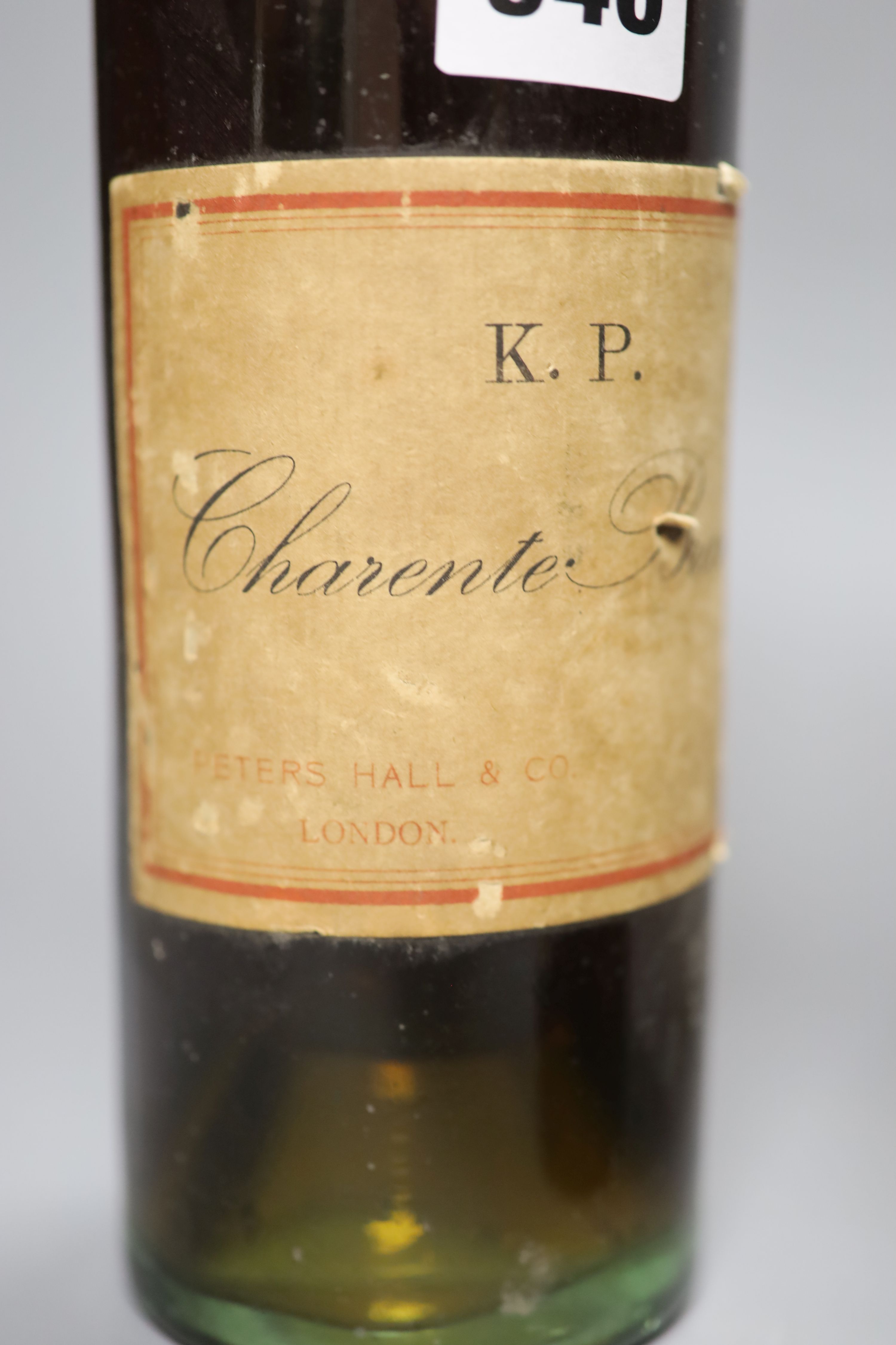 A 1915 bottle of Heidsieck, a bottle of Barsac and a K.P. Charente brandy by Peters Hall & Co, London